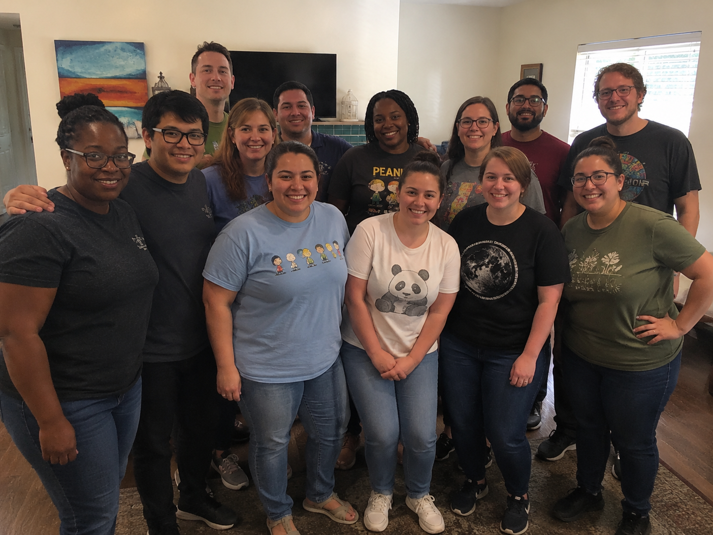 A large, diverse group of smiling Maystar staff members posing together indoors